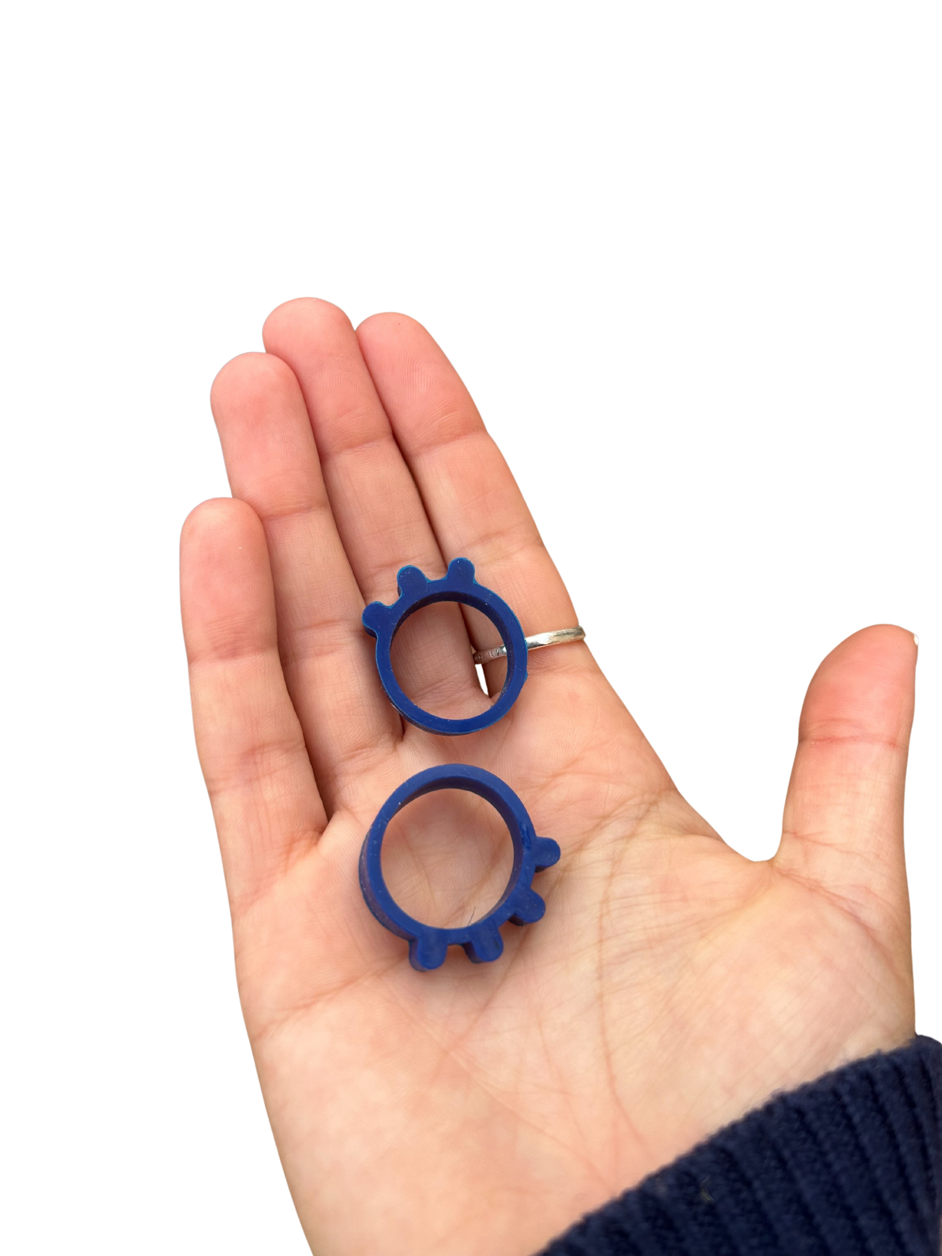 Close-up of Pheelio's tactile ridges being felt by fingertips, showing the four-times-per-day indicator